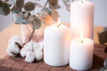 Image showing candles and branches of eucalyptus on table