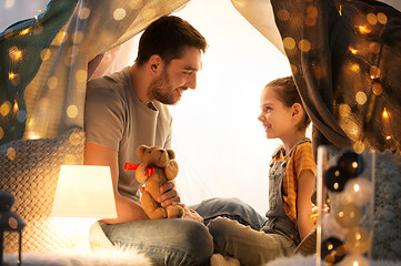 Image showing happy family playing with toy in kids tent at home