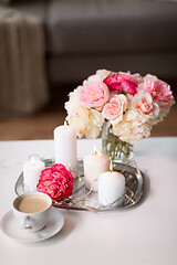 Image showing coffee, candles, garland and flowers on table