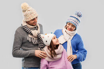 Image showing happy family in winter clothes on grey background