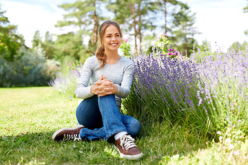 Image showing young woman and lavender flowers at summer garden