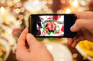 Image showing hands photographing food at christmas dinner