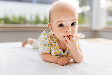 Image showing sweet baby girl lying on white blanket