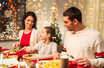 Image showing happy family having christmas dinner at home