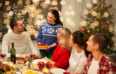 Image showing happy friends having christmas dinner at home