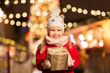 Image showing happy girl with gift box at christmas market