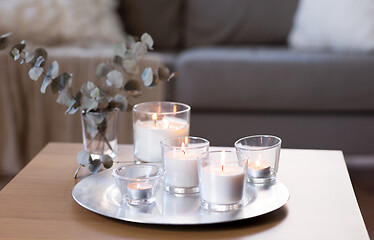 Image showing burning fragrance candle on table at cozy home