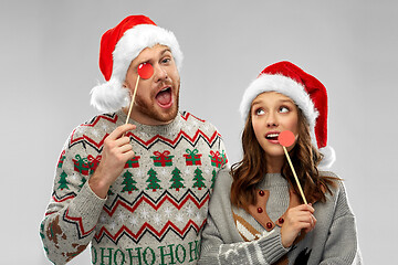 Image showing couple with christmas party props in ugly sweaters