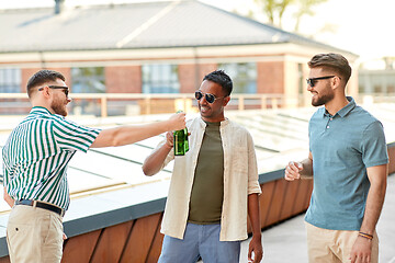 Image showing happy male friends drinking beer at rooftop party