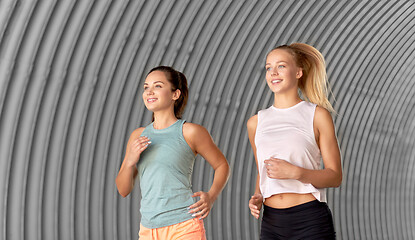 Image showing young women or female friends running outdoors