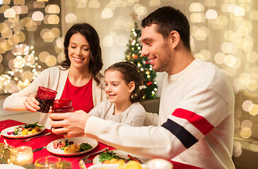 Image showing happy family having christmas dinner at home