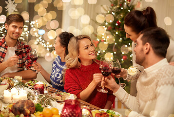 Image showing friends celebrating christmas and drinking wine