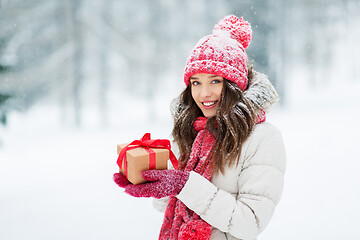 Image showing happy young woman with christmas gift in winter