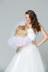 Image showing beautiful bride girl with spitz bride on gray background