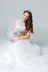 Image showing beautiful bride girl with spitz bride on gray background