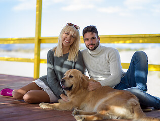 Image showing Couple with dog enjoying time on beach