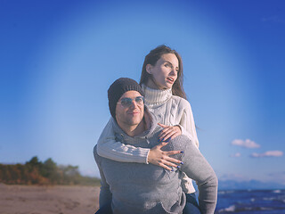 Image showing couple having fun at beach during autumn