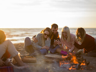 Image showing Friends having fun at beach on autumn day