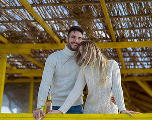 Image showing young couple drinking beer together at the beach