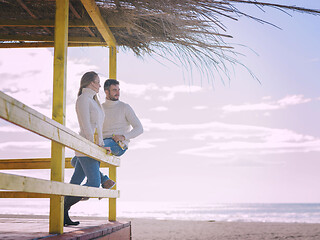 Image showing young couple drinking beer together at the beach