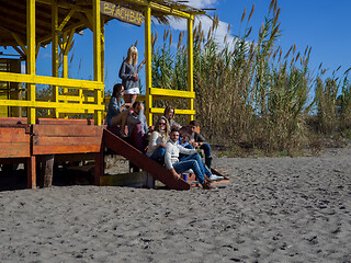 Image showing Group of friends having fun on autumn day at beach