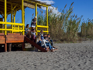 Image showing Group of friends having fun on autumn day at beach