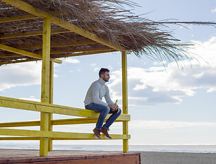 Image showing man drinking beer at the beach