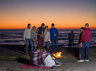 Image showing Friends having fun at beach on autumn day