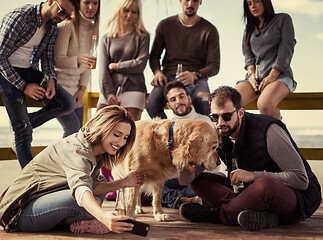 Image showing Group of friends having fun on autumn day at beach