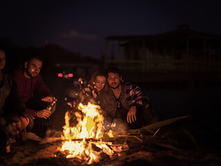 Image showing Couple enjoying with friends at night on the beach