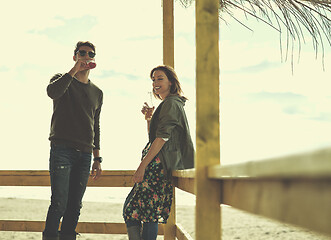 Image showing young couple drinking beer together at the beach