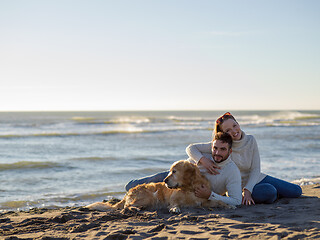 Image showing Couple with dog enjoying time on beach