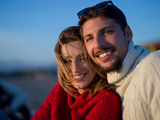 Image showing couple on a beach at autumn sunny day