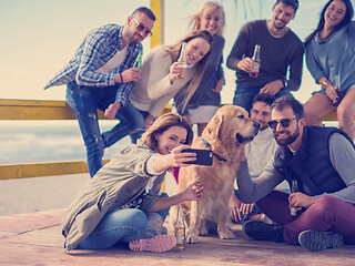 Image showing Group of friends having fun on autumn day at beach