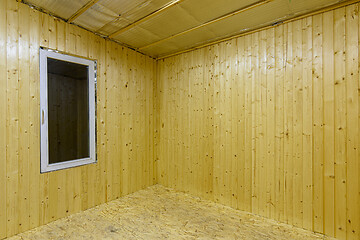 Image showing Fragment of a room, finished with wooden clapboard, with a window