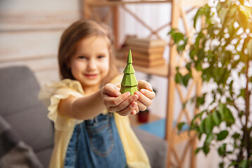 Image showing Little girl in creativity of the house. Happy kid makes handmade toys for games or New Year celebration