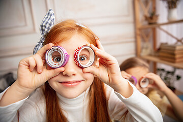 Image showing Two little children, girls together in creativity of the house. Happy kids make handmade toys for games or New Year celebration