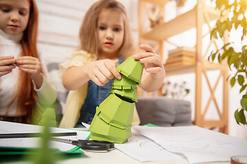 Image showing Two little children, girls together in creativity of the house. Happy kids make handmade toys for games or New Year celebration