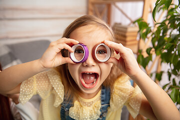 Image showing Little girl in creativity of the house. Happy kid makes handmade toys for games or New Year celebration