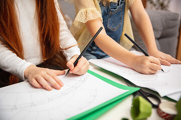 Image showing Close up hands of two little children, girls together in creativity of the house. Kids make handmade toys for games or New Year celebration