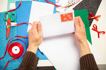 Image showing Man making greeting card for New Year and Christmas 2021 for friends or family, scrap booking, DIY