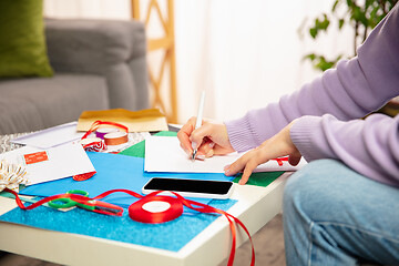 Image showing Woman making greeting card for New Year and Christmas 2021 for friends or family, scrap booking, DIY