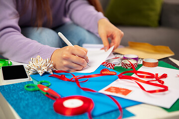 Image showing Woman making greeting card for New Year and Christmas 2021 for friends or family, scrap booking, DIY