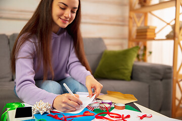 Image showing Woman writing letter, greeting card for New Year and Christmas 2021 for friends or family