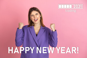 Image showing Caucasian young woman\'s portrait isolated on pink studio background, celebrating New 2021 Year and Christmas