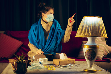 Image showing Woman wrapped in a plaid wearing face mask trying to protect from somebody\'s sick