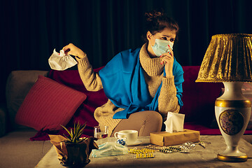 Image showing Woman wrapped in a plaid wearing face mask trying to protect from somebody\'s sick