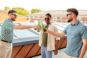 Image showing happy male friends drinking beer at rooftop party