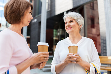 Image showing senior women with shopping bags and coffee in city