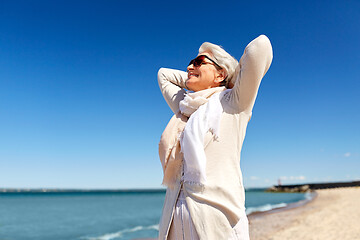 Image showing portrait of senior woman in sunglasses on beach